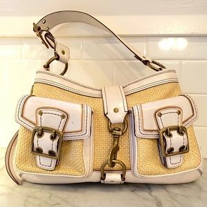 A vintage straw and leather Coach purse.